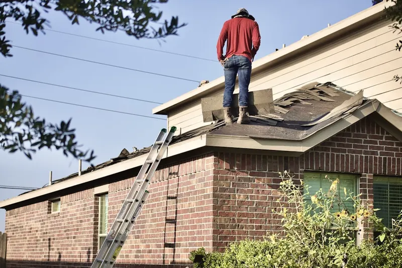 Professional roofer working on a residential roof in Maffett